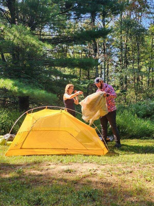 Lunar demonstrating and explaining benefits of semi free standing tent